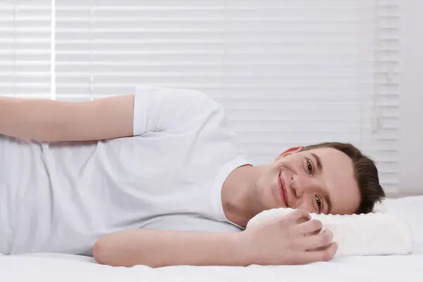 Man lying on orthopedic pillow at home