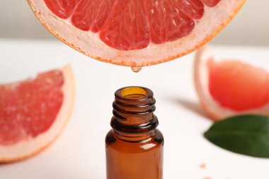 Meyve suyundan şişeye damlayan greyfurt suyu.