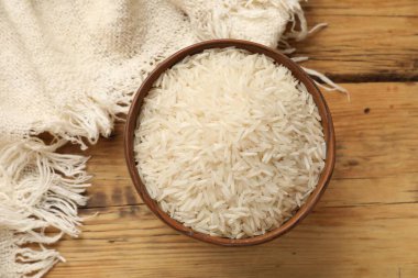 Tabakta çiğ basmati pilavı, ahşap masa, üst manzara.