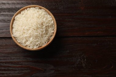 Tabakta çiğ basmati pilavı, ahşap masa, üst manzara. Metin için boşluk