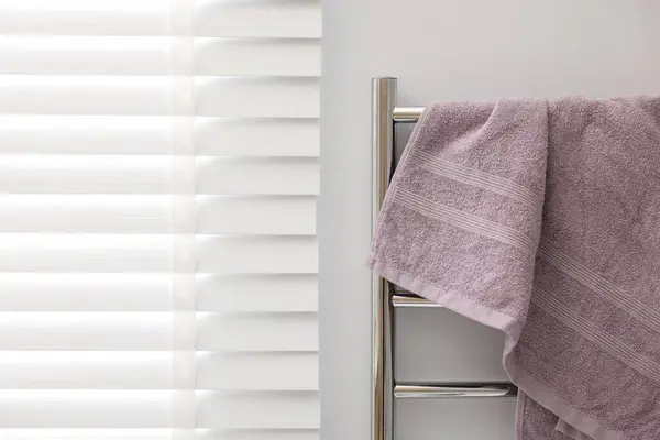 Clean terry towel on heated rail indoors