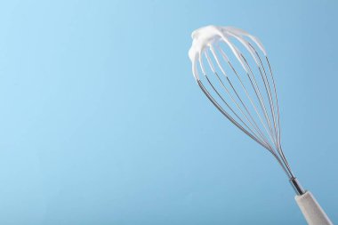 Açık mavi arka planda çırpılmış kremalı çırpma. Metin için boşluk