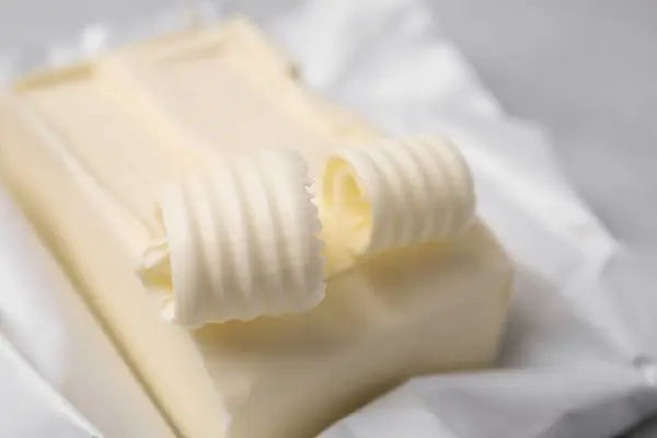 Tasty butter and curls on table, closeup