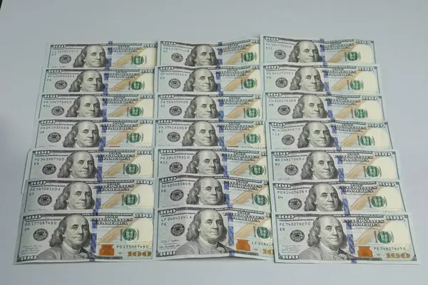 Money exchange. Dollar banknotes on gray background