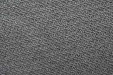 Arka plan olarak gri örülmüş kumaş dokusu, üst görünüm