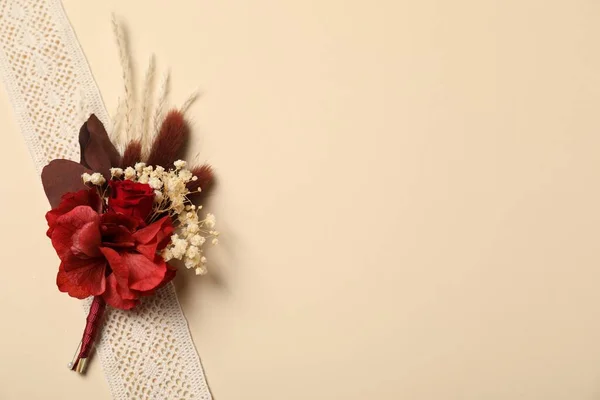 stock image Stylish red boutonniere and ribbon on beige background, top view. Space for text