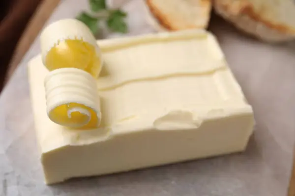 Tasty butter and curls on table, closeup