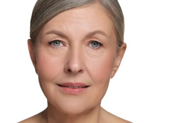 Beyaz arka planda sağlıklı cildi olan güzel, olgun bir kadın.