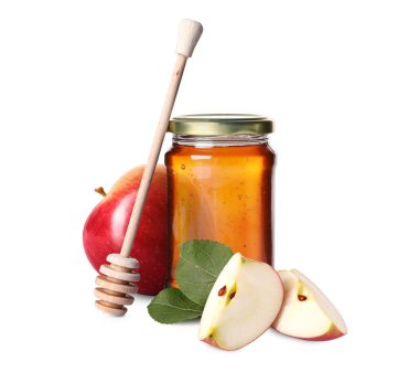 Cam kavanozda bal, beyaz elmalar ve dipper.