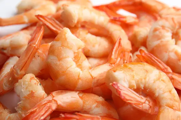 Pile of delicious peeled shrimps as background, closeup