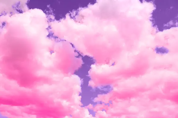 Fluffy clouds floating in beautiful purple sky
