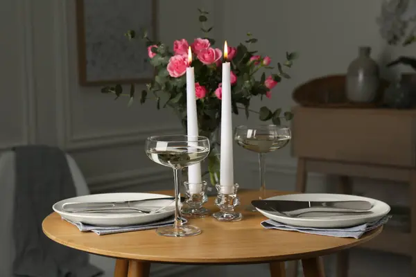 Romantic table setting with candles and flowers