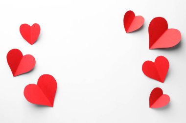 Kağıt kalpler beyaz arka planda, düz yatıyordu. Metin için boşluk