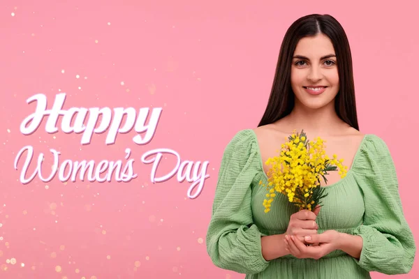 Happy Women\'s Day - March 8. Attractive lady with mimosa flowers on pink background