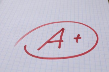 Okul derecesi. Not defteri kağıdında artı işareti olan kırmızı harf A, kapat