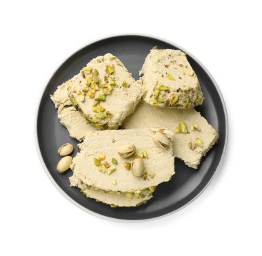 Pieces of tasty halva with pistachios on white background, top view clipart