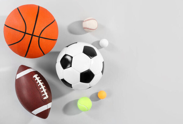 Many different sports balls on gray background, flat lay. Space for text