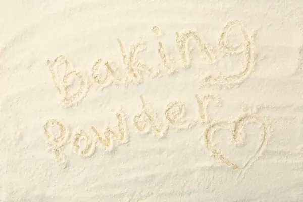 Words Baking Powder and heart written on powder, top view