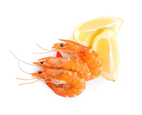 Delicious cooked shrimps and lemon isolated on white, top view