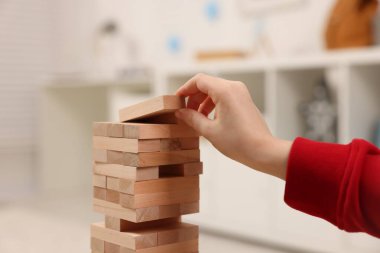 Küçük çocuk evde Jenga oynuyor, yakın plan.
