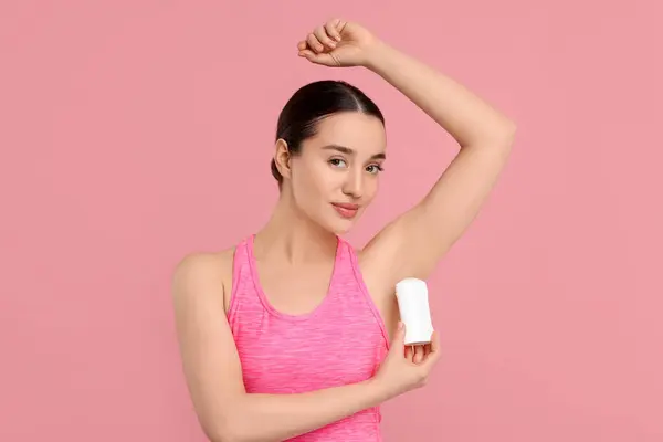 Piękna Kobieta Stosująca Dezodorant Różowym Tle — Zdjęcie stockowe