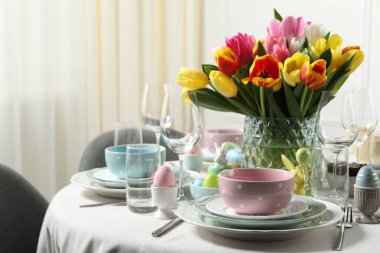 Paskalya kutlaması. Güzel çiçekli ve boyalı yumurtalı şenlik masası.