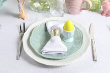 Paskalya kutlaması. Zarif bulaşık takımları ve boyalı yumurtalarla şölen masası.