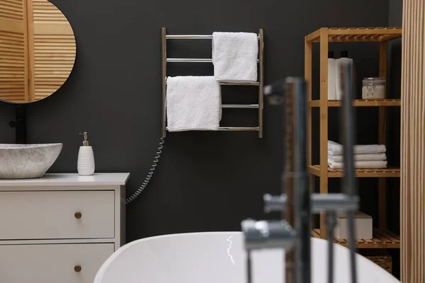 Stylish bathroom interior with heated towel rail and modern furniture