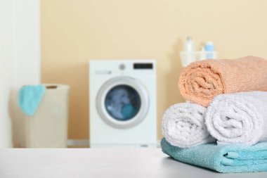 Çamaşır odasındaki ışık masasında temiz havlular, mesaj için yer.