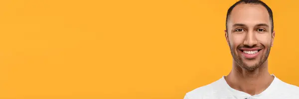 stock image Man with clean teeth smiling on orange background, space for text. Banner design