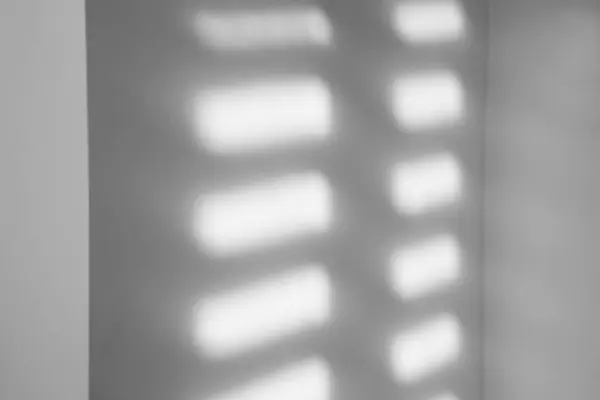 Light and shadows falling on white wall