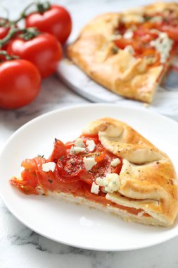 Beyaz mermer masa üzerinde domates ve peynirli (Caprese galette) leziz galette, yakın çekim