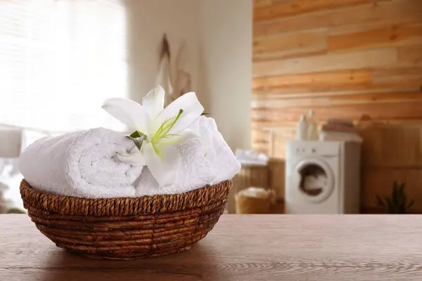 Clean Towels Lily Flower Wicker Basket Wooden Table Laundry Room — Stock Photo, Image