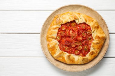 Beyaz ahşap masa üzerinde lezzetli domates galeti (Caprese galette), üst manzara. Metin için boşluk