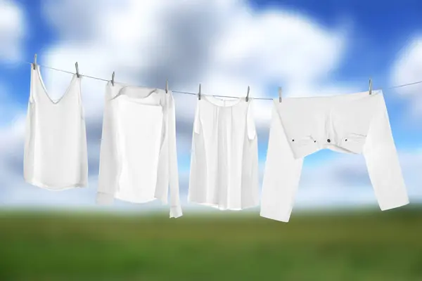 Different clothes drying on washing line outdoors