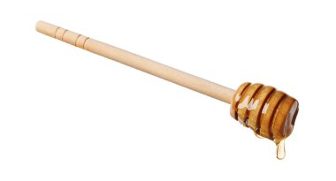 Beyaz arka planda doğal bal damlıyor.