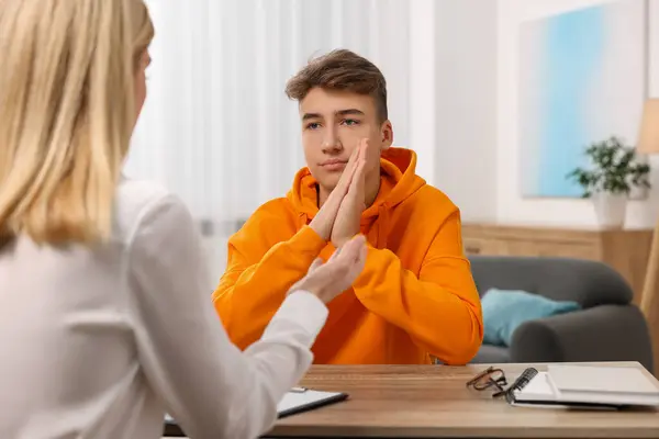 stock image Psychologist working with teenage boy at table in office