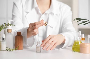 Dermatolog, beyaz masada gerekli yağı test ediyor.
