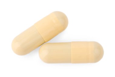 Vitamin kapsülleri beyaz, üst görünümde izole edilmiş. Sağlık takviyeleri