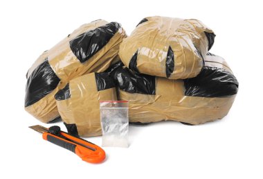 Narkotik ve kırtasiye bıçağı olan paketler beyaza izole edilmiş.
