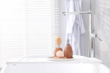 Banyodaki küvette farklı kişisel bakım ürünleri ve aksesuarlar.