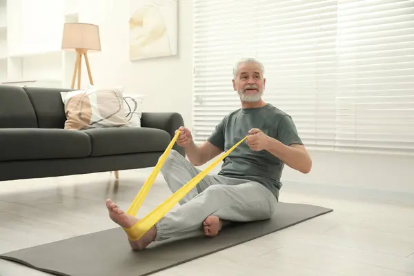 Senior Man Doing Exercise Fitness Elastic Band Mat Home — Stock fotografie