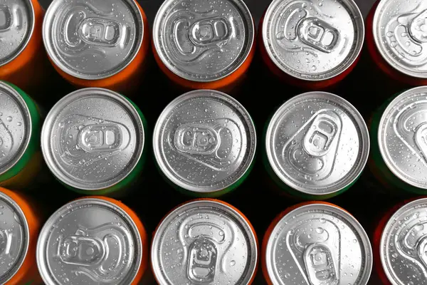 Energy drink in wet cans, top view. Functional beverage