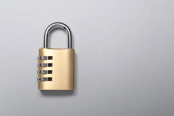 One steel combination padlock on grey background, top view. Space for text