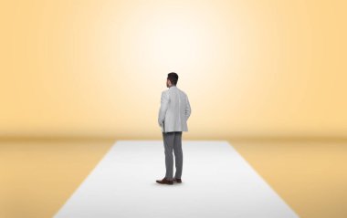 Soluk sarı duvarın önünde duran adam