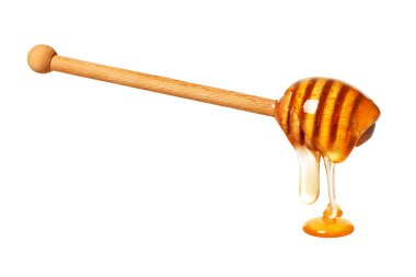 Beyaz arka planda doğal bal damlıyor.