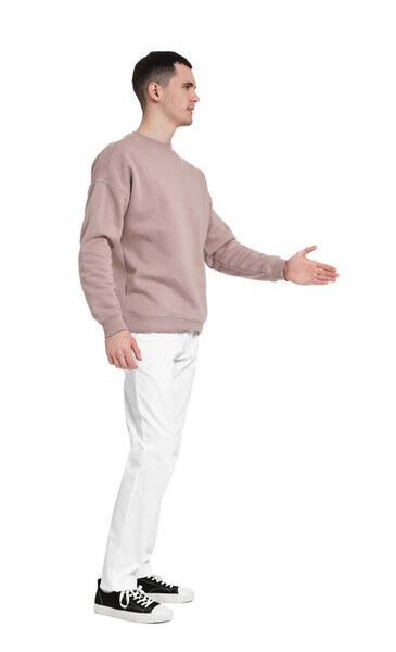 Handsome young man greeting someone on white background