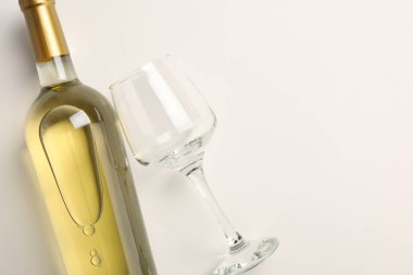 Pahalı bir şişe beyaz şarap ve arka planda şarap kadehi, üst manzara. Metin için boşluk