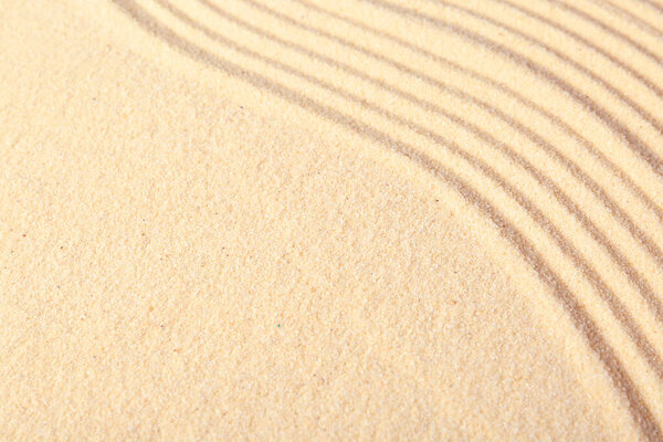 Zen rock garden. Wave pattern on beige sand