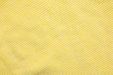 Arka plan olarak yumuşak sarı kumaşın dokusu, üst görünüm